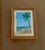 A delightful original watercolor depicting a peaceful tropical beach beneath a graceful, arching palm tree. Three figures...
