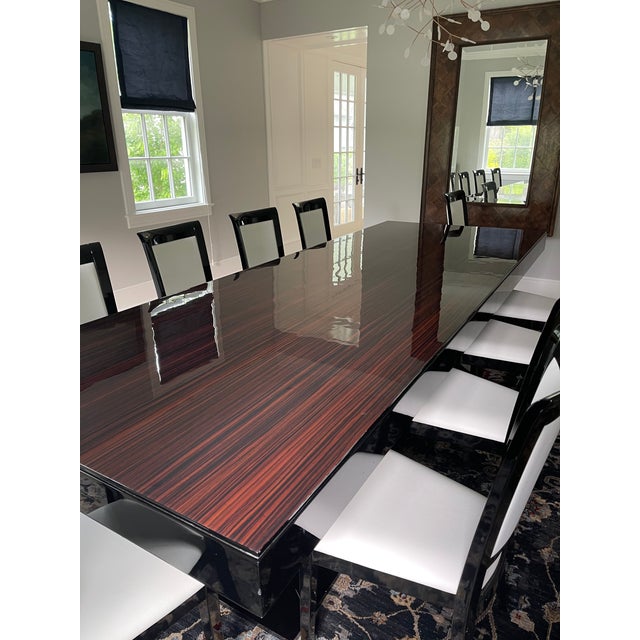 Art Deco dining table and 12 chairs. Table is 130 inches long, 47 wide and 30 inches high. Chair are a soft white leather,...