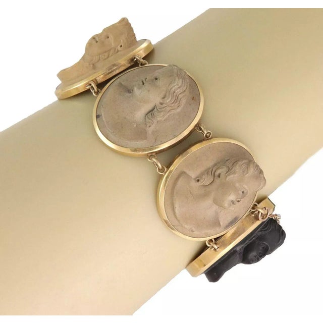 This is a lovely antique bracelet, crafted from 18k yellow gold with oval shape frame, each with a raised carved cameo...