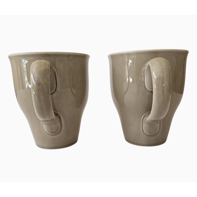 Set of two Russel Wright Oneida MCM style stoneware tall gray coffee mugs. Each mug holds 1-3/4 cups (14 ounces) and...