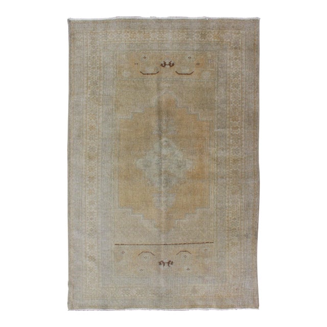 Vintage Turkish Oushak Rug in Faded Gold and Soft Gray With Subtle Medallion 3′6″ × 5′9″ For Sale