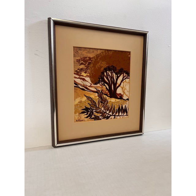 The vintage mid-century modern batik-style abstract painting features a landscape scene characterized by earthy tones of...