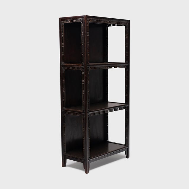 This darkly lacquered bookcase once stood in the center of a traditional Chinese scholars' studio, displaying a collection...