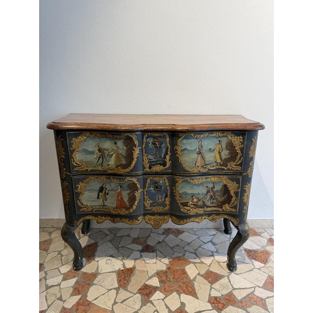 A curved, lacquered, and painted chest of drawers from the first half of the 18th century. Sicily. This piece is...