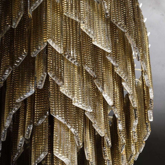 A breathtaking Modernist six-tier chandelier, crafted from hand-blown Murano glass with a striking oblong silhouette and...