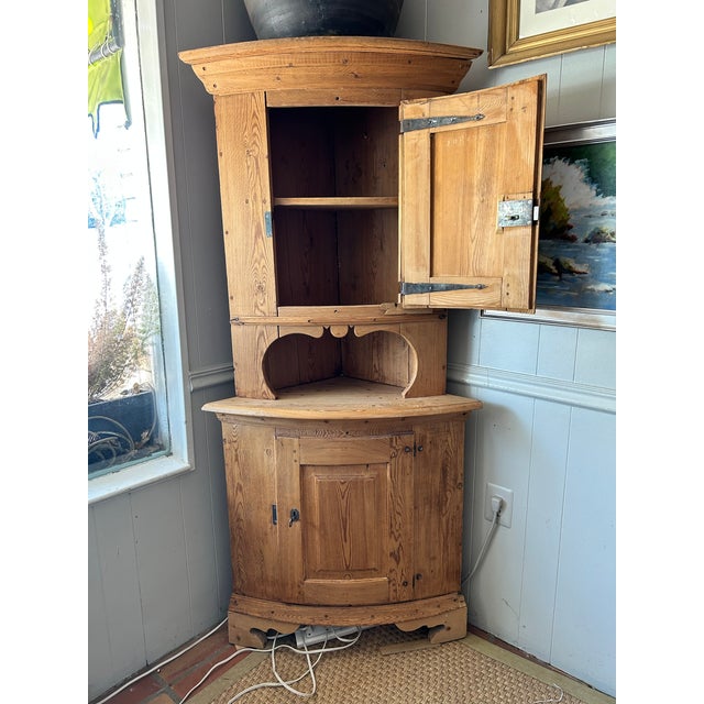 19th Century. Antique Swedish Farmhouse Pine Corner Cabinet. Solid pine construction with a natural wood finish. Designed...