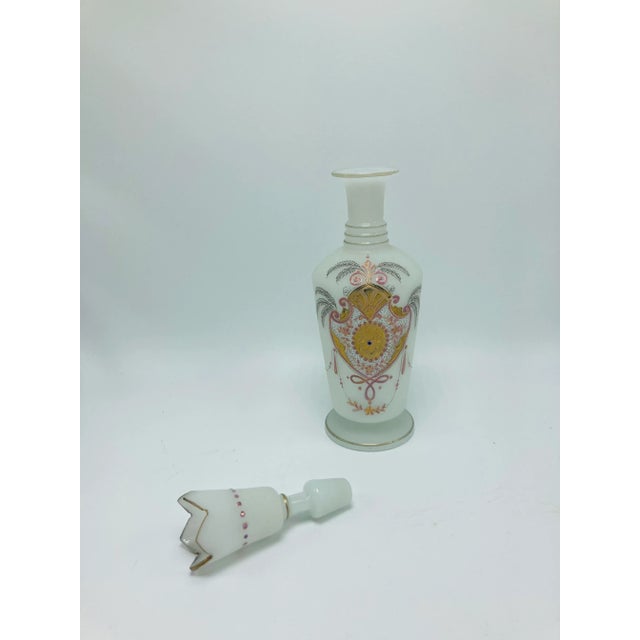 Lovely, feminine bottle with stopper. Such a beautiful decorative piece in frosted white with pink and gold accents