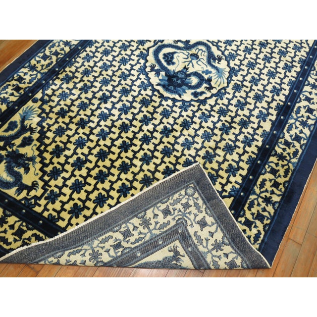 Vintage Chinese animal dragon rug in excellent medium even pile condition on creamy yellow colored ground. Measures: 5' x 8'.