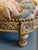 This is an antique footstool with a floral tapestry. It has Giltwood engraved wood and a spectacular floral design...