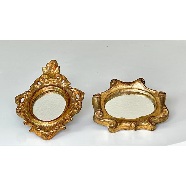 A charming pair of mid-century Italian Florentine small accent wall mirrors, circa 1960. Sourced from Florence, Italy,...