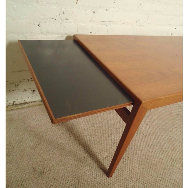 Mid-Century Modern teak table with extending leaves. In addition to the great modern style, tapered legs and teak grain,...