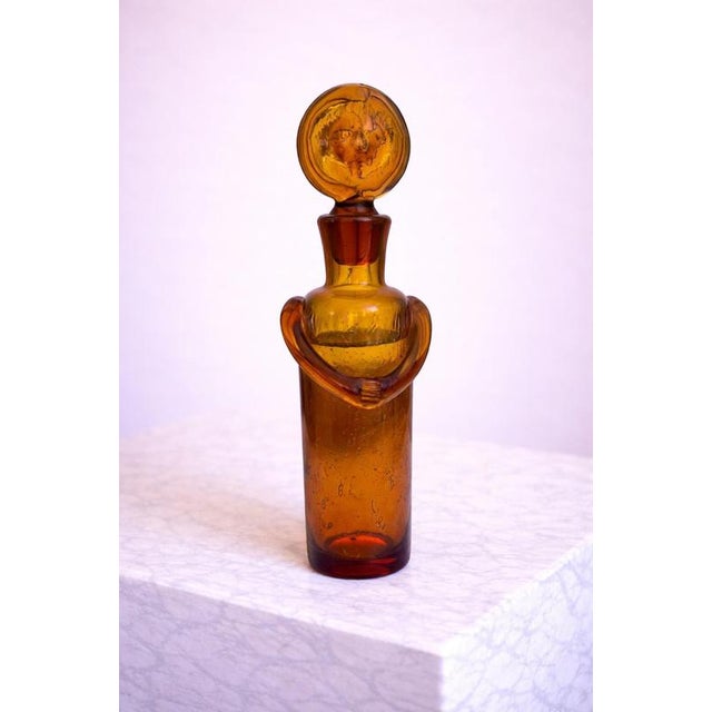 A rare and highly sculptural amber glass decanter designed by Erik Höglund for Boda Glasbruk in the 1950s, exemplifying...