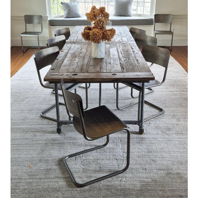 Extra long vintage table crafted from European salvaged solid wood and cast iron solid legs with casters. Simplicity and...