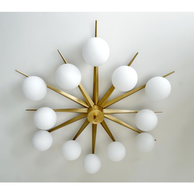 Italian midcentury flush mount with 12 matte white Murano glass globes mounted on solid brass frame in satin brass finish...