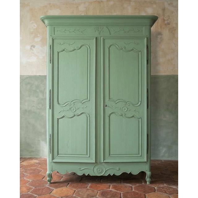 Elegant Soft Green Painted French Marriage Armoire from the 19th Century. Presenting a French Louis XV style painted...