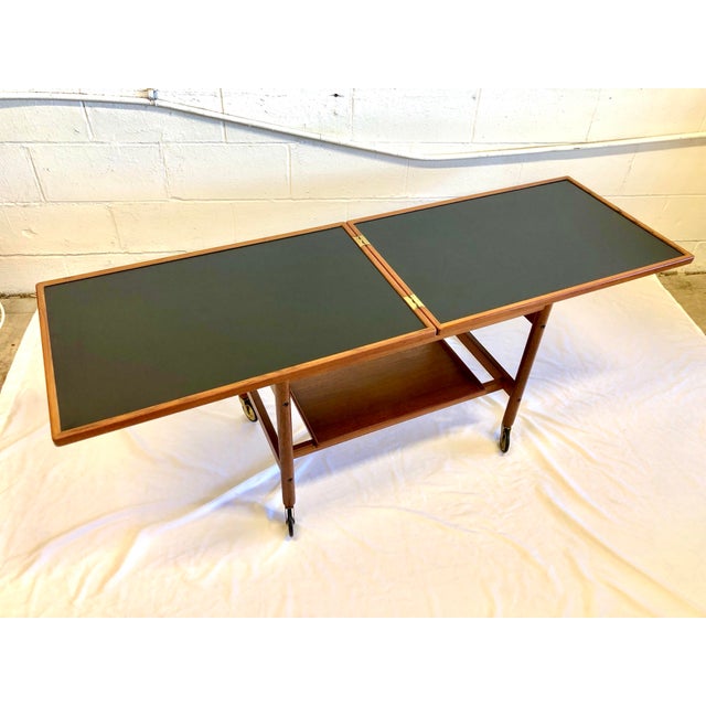 Handsome all teak cocktail cart with option to double the top length. The teak top is hinged on one side for easy flip-...