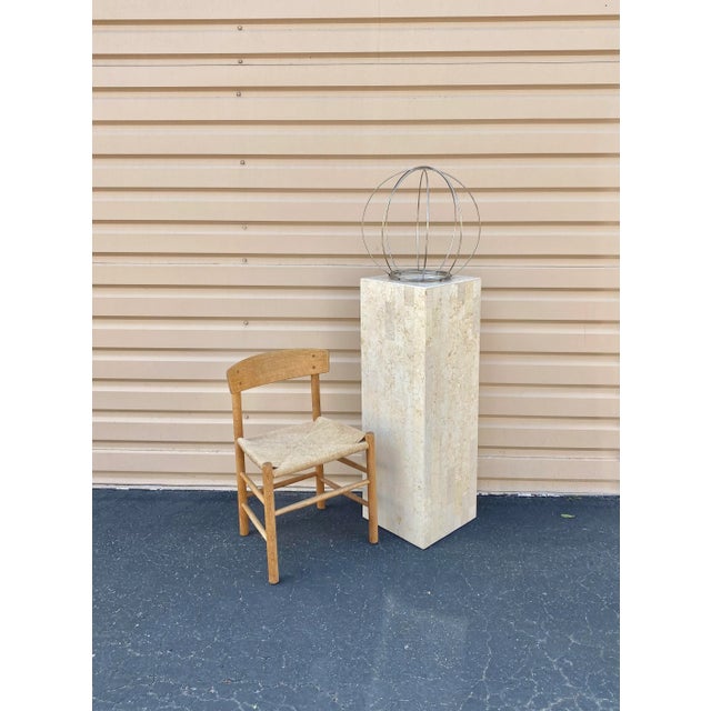 Industrial-style decorative oversized spherical sculptural object. This piece is comprised of four individual steel rings...