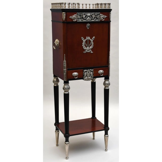 This is a striking and elaborate Victorian-era silver-plated cutlery cabinet containing a 135 piece estate set. The front...