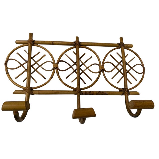 1960s rattan wall-mounted coat rack in a rectangular shape with three hooks. It embodies the style of the Italian Riviera...
