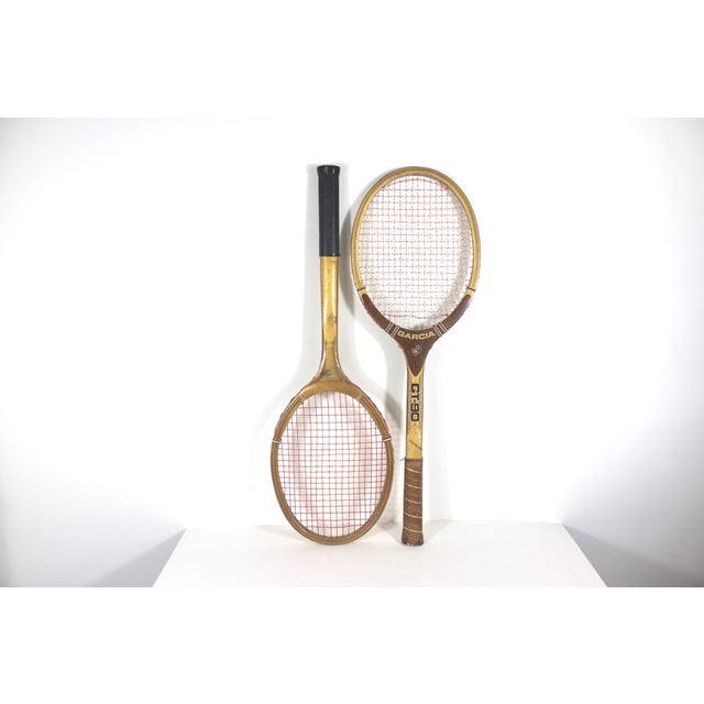 Width: 9 inches Height: 27 inches Depth: 1.5 inches Vintage curated set of two wooden tennis racquets for designer...