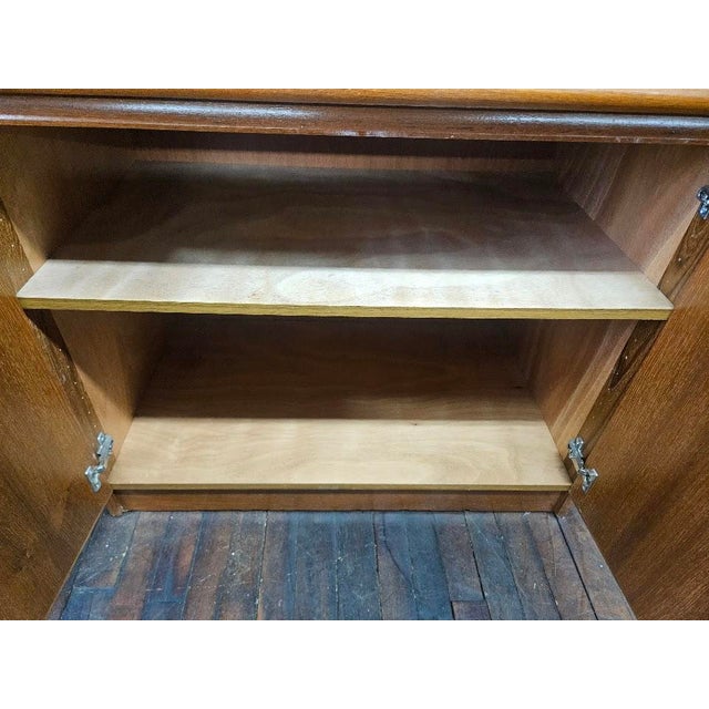 Mid-Century Modern teak cabinet crafted in Denmark. The front features two seamlessly matched teak doors that showcase...