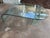 Beautiful waterfall style curved glass coffee table, vintage Post Modern and believed to be from Italy. Two separate...