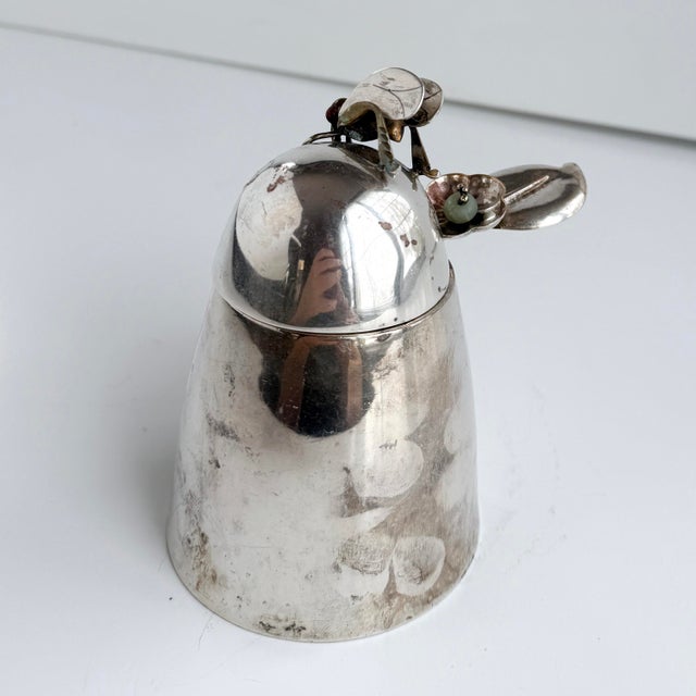A lovely piece from Los Castillo Taxco. A beehive shaped sterling silver-plate lidded honey pot with a mixed metal applied...