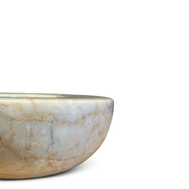 Carved from natural onyx in soft beige and cream, marbled and striated in patterns only the earth could create. Cradling a...