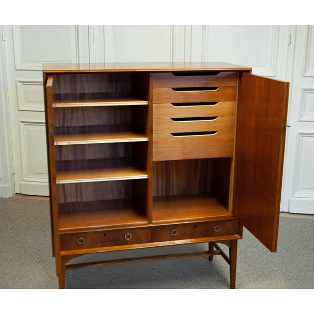 Elegant Swedish cabinet from the 1950s, crafted in warm teak with beautifully patterned veneer doors. The interior...