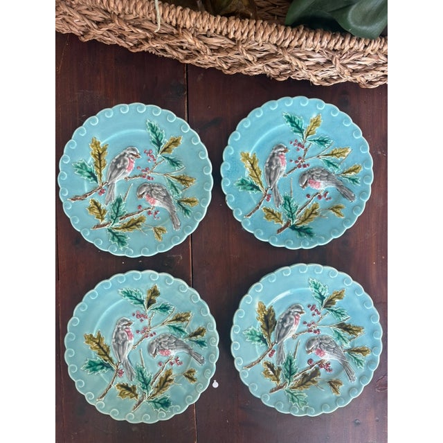 Sarreguemines majolica plates, France, circa 1865–1890. Turquoise ground with molded relief decoration of birds perched on...