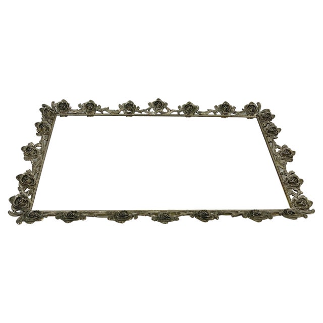 Hollywood Regency gilded vanity tray. Large rectangular hand forged ornate tray with ornate rose floral design. The...
