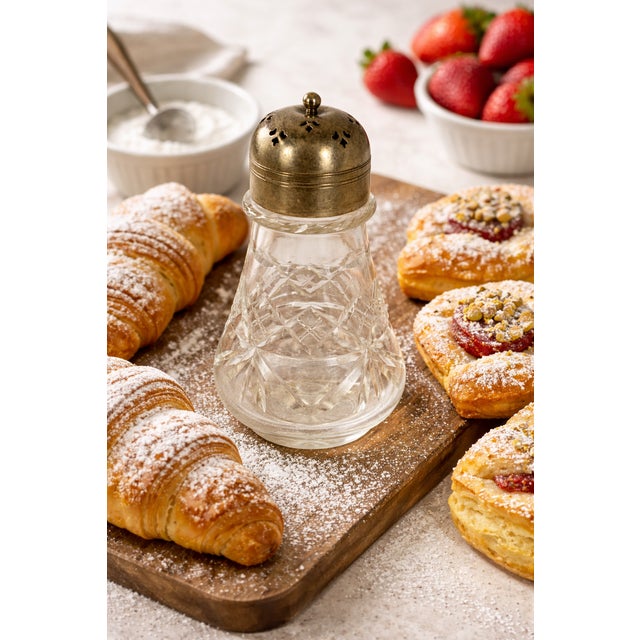 This is an elegant Early Edwardian silver-plated and cut glass sugar shaker, also known as a muffineer. This refined table...