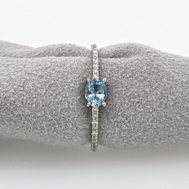 This beautiful ring features an oval east west aquamarine gemstone in 14k yellow gold with natural earth-mined diamonds. A...