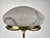 Elegant statement table lamp with a polished brass base and a beautiful marbled glass shade. The sculptural dome form,...