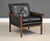 A mid century modern black leather lounge chair with rosewood arms designed by Knut Saeter for Vatne Möbler. Beautiful...
