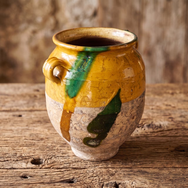 Traditionally crafted in southwestern France, this hand-thrown earthenware pot à confit features a warm yellow ochre glaze...