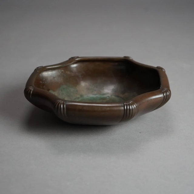 An antique Chinese low bowl offers bronze construction with stylized corner elements, signed on base as photographed,...