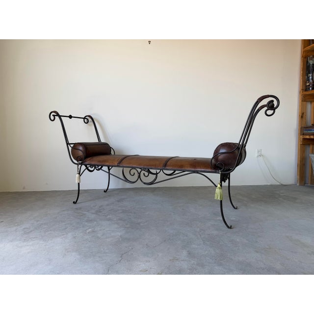Striking vintage rustic bench featuring an elegant wrought iron frame with dramatic scrolled arms and decorative ironwork...