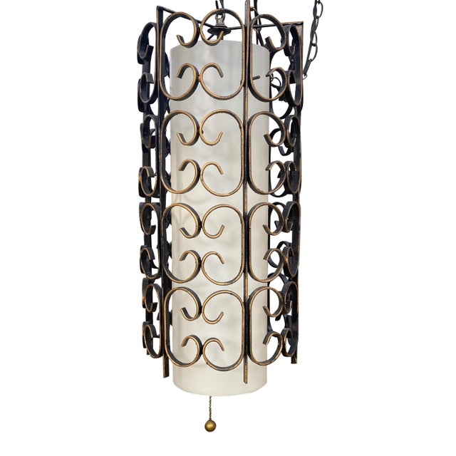 Mid Century scroll wrought iron hanging light with white cylinder shade and chain pull switch. Has a 14’ cord which allows...