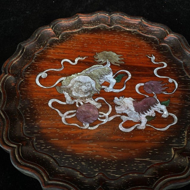 Striking scalloped petal-edge round hardwood tea tray, beautifully inlaid with colorful mother-of-pearl shell. The central...
