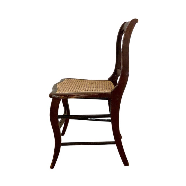 A distinctive antique side chair combining graceful Victorian-era ornament with the more linear, architectural character...
