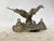 Elegant vintage inkwell featuring a sculpture of an eagle with outstretched wings. The base has two inkwells with lids. A...
