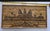 The framed art appears to be a Khmer wood mosaic or marquetry art piece depicting Angkor Wat, a renowned temple complex in...