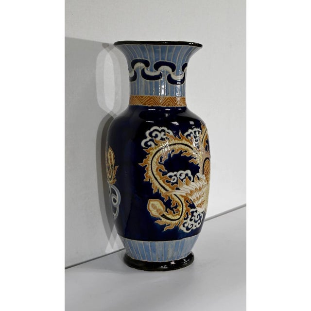 Large necked vase, whose porcelain is partially covered with a rich decoration of a "fenghuang", or Chinese phoenix,...