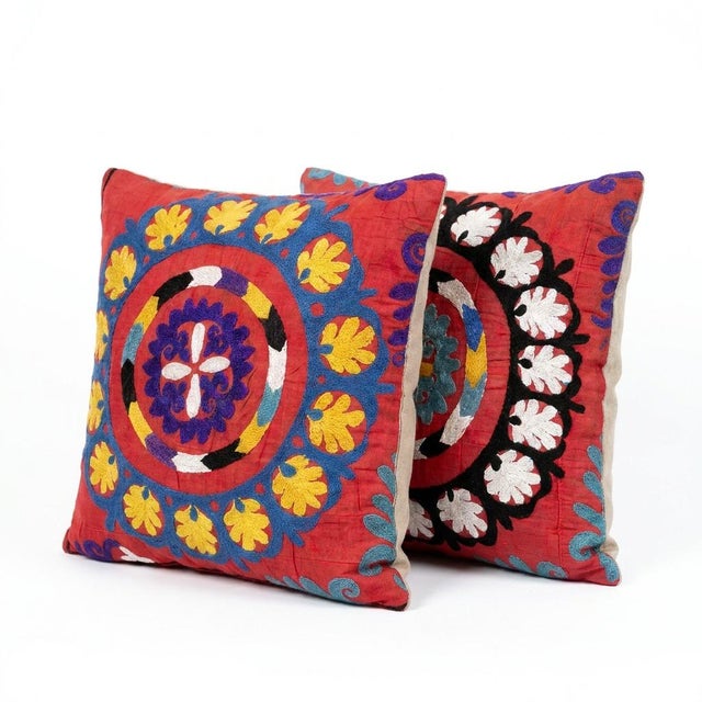 This beautiful 20'' x 20'' hand-embroidered Suzani pillow cover set was made from authentic Uzbek cotton fabric. The...