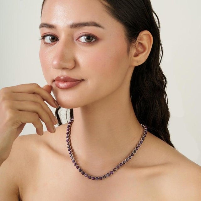 This tennis necklace features a striking line of natural star ruby gemstones, totaling 46.62 carats, set in solid 925...