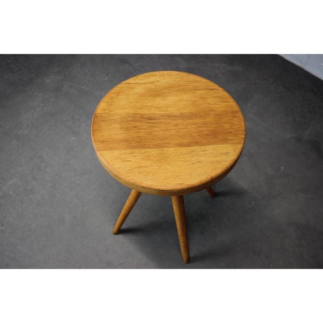 A mid-century atelier stool made in Czechoslovakia in the 1960s, featuring a solid beech wood round seat and a height-...