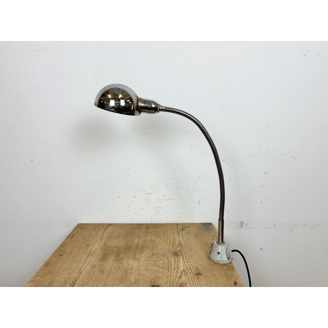 Industrial chrome flexible gooseneck table lamp made in Italy during the 1960s. Original vintage condition. The socket...