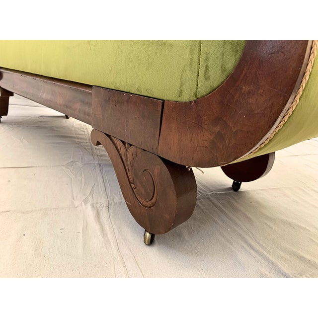 An exceptional 19th-century Regency-style mahogany settee that beautifully bridges historical charm and contemporary...