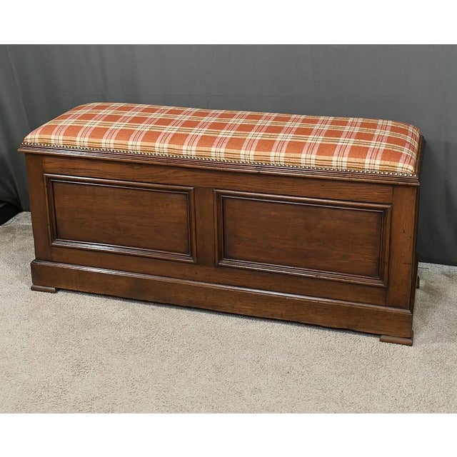 Solid oak storage bench offering spacious storage space and comfortable seating thanks to its padded cushion in orange...